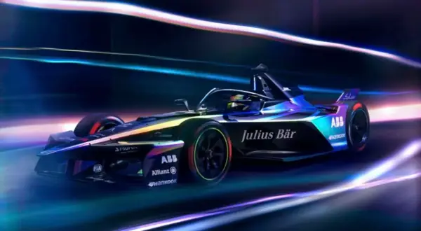 En futuristisk Formel E-bil, med texten "Julius Bär" och "ABB", susar fram i neonljus. F1 frön för framtiden.