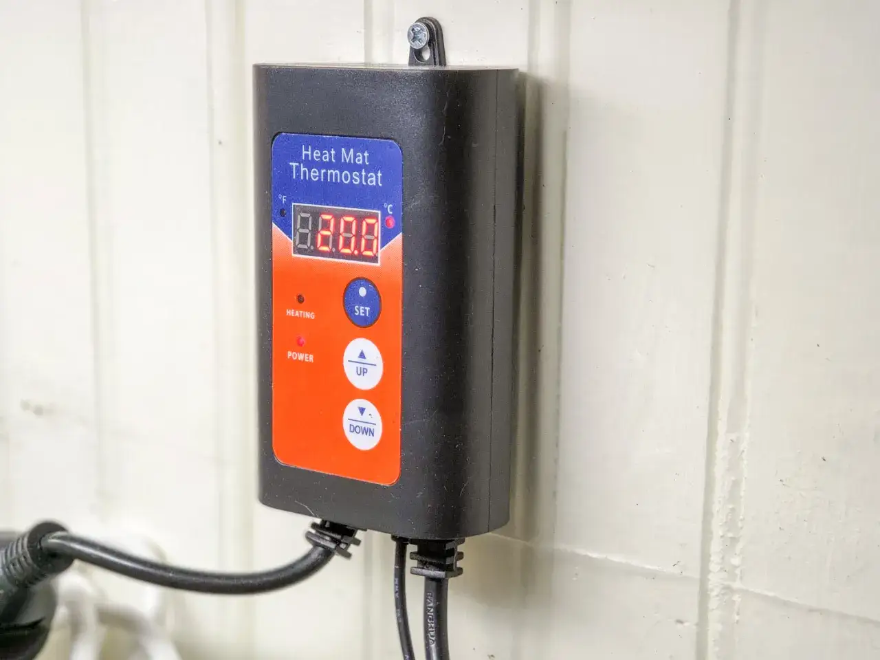 Svart v&auml;ggmonterad v&auml;rmemattatermostat med digital display och knappar f&ouml;r inst&auml;llning av temperatur. Ett praktiskt termostat uttag f&ouml;r att reglera v&auml;rmen.